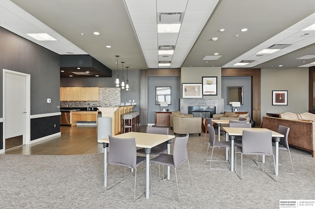 3200 Farnam Ct Unit 3409, Omaha, NE 68131 - dining room with a glass covered fireplace, light tile patterned flooring, light colored carpet, and recessed lighting