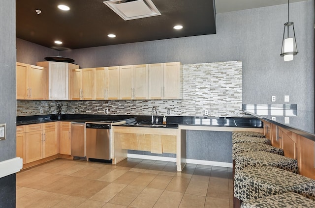 3200 Farnam Ct Unit 3409, Omaha, NE 68131 - kitchen with light brown cabinets, tasteful backsplash, dark countertops, stainless steel dishwasher, and light tile patterned floors