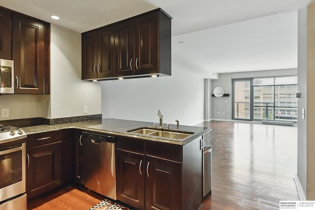 3200 Farnam Ct Unit 3409, Omaha, NE 68131 - kitchen with appliances with stainless steel finishes, a sink, light wood-type flooring, open floor plan, and dark brown cabinets