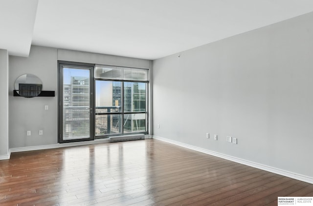 3200 Farnam Ct Unit 3409, Omaha, NE 68131 - unfurnished room featuring wood finished floors and baseboards