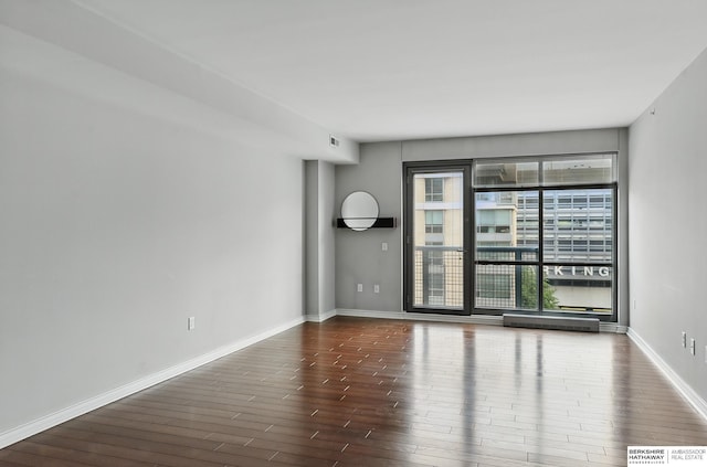 3200 Farnam Ct Unit 3409, Omaha, NE 68131 - spare room featuring dark wood finished floors and baseboards