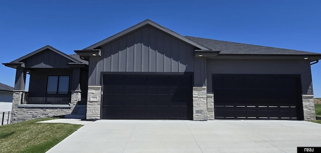 12003 S 109th St, Papillion, NE 68046 - view of front of home with a garage, stone siding, board and batten siding, concrete driveway, and a shingled roof