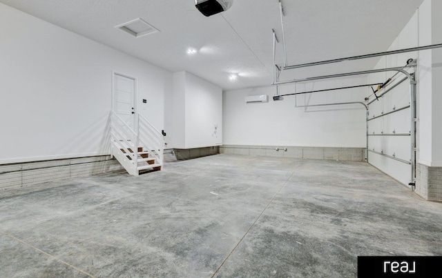 12003 S 109th St, Papillion, NE 68046 - garage with a garage door opener and a wall mounted AC