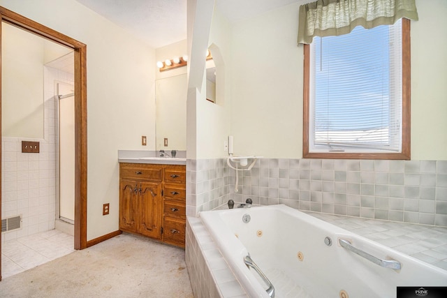 13602 S 36th St, Bellevue, NE 68123 - full bath with a tub with jets, vanity, a shower, tile walls, and tile patterned floors