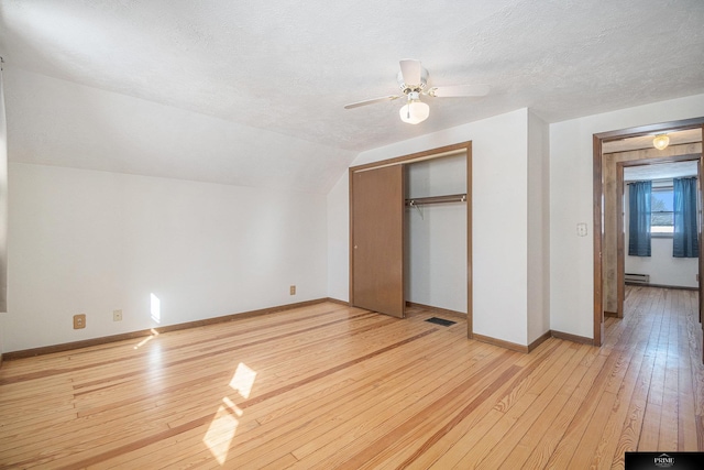 13602 S 36th St, Bellevue, NE 68123 - unfurnished bedroom with light wood finished floors, a closet, baseboards, a textured ceiling, and lofted ceiling