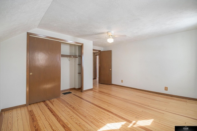 13602 S 36th St, Bellevue, NE 68123 - unfurnished bedroom featuring a textured ceiling, light wood-style flooring, a closet, baseboards, and a ceiling fan