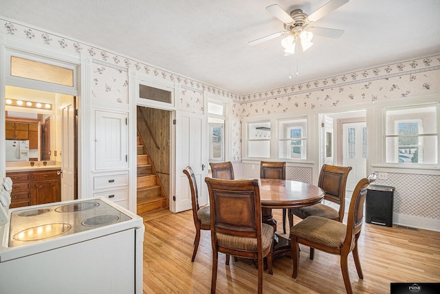 13602 S 36th St, Bellevue, NE 68123 - dining area with wallpapered walls, light wood finished floors, ceiling fan, and healthy amount of natural light