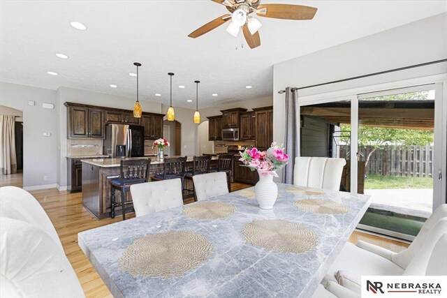 18402 Polk St, Omaha, NE 68135 - dining room featuring arched walkways, recessed lighting, ceiling fan, and light wood-style flooring