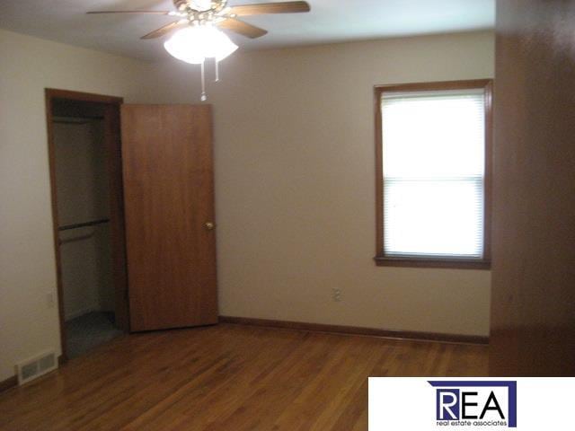 4521 A St, Omaha, NE 68106 - unfurnished bedroom with wood finished floors and a ceiling fan