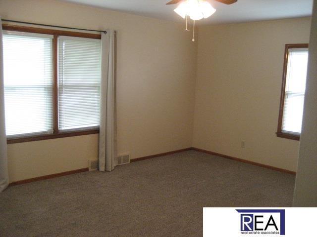 4521 A St, Omaha, NE 68106 - carpeted empty room featuring ceiling fan and plenty of natural light