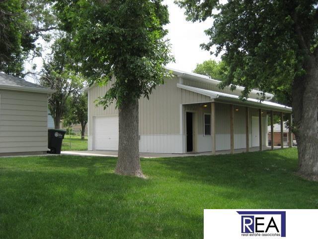 4521 A St, Omaha, NE 68106 - rear view of property featuring a detached garage and a lawn