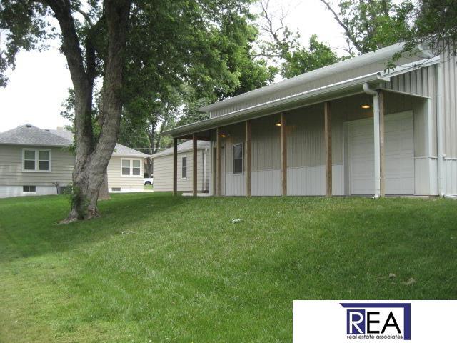 4521 A St, Omaha, NE 68106 - view of grassy yard featuring a garage