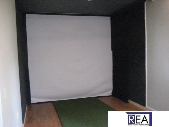 4521 A St, Omaha, NE 68106 - cinema room featuring golf simulator and wood finished floors