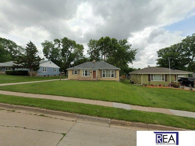 4521 A St, Omaha, NE 68106 - ranch-style house with a front yard and a chimney