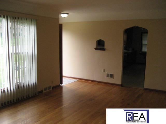 4521 A St, Omaha, NE 68106 - unfurnished room with arched walkways and wood finished floors