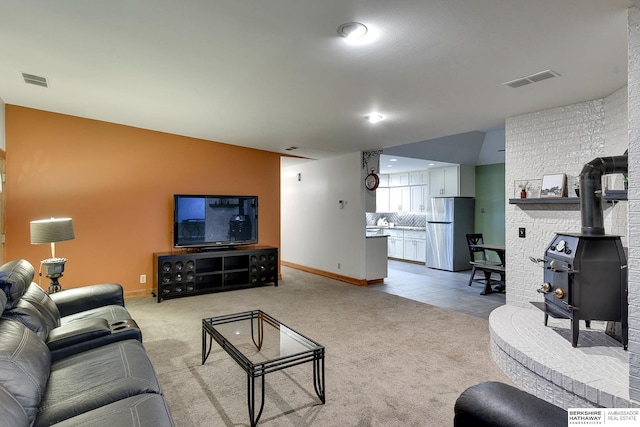 4128 State St, Omaha, NE 68112 - carpeted living room with a wood stove and baseboards