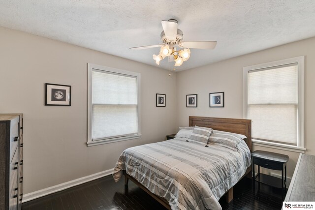 5042 Corby St, Omaha, NE 68104 - bedroom featuring dark wood-type flooring, a ceiling fan, and a textured ceiling