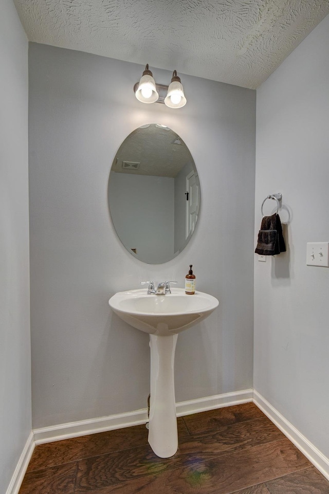 10505 Rosewater Pkwy, Bennington, NE 68007 - bathroom featuring wood finished floors and a textured ceiling