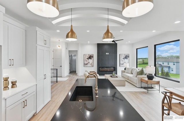 16951 Benjamin St, Bennington, NE 68007 - kitchen featuring light wood finished floors, white cabinets, pendant lighting, and recessed lighting