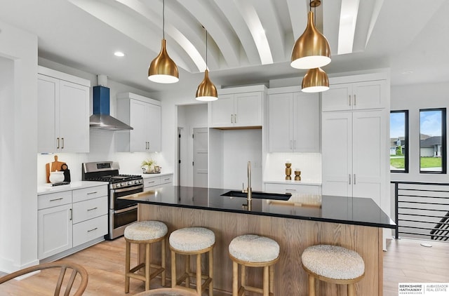 16951 Benjamin St, Bennington, NE 68007 - kitchen featuring wall chimney range hood, double oven range, recessed lighting, light wood finished floors, and a breakfast bar area