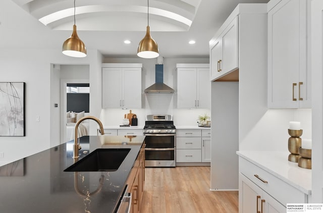16951 Benjamin St, Bennington, NE 68007 - kitchen with gas range, wall chimney exhaust hood, recessed lighting, pendant lighting, and light wood finished floors