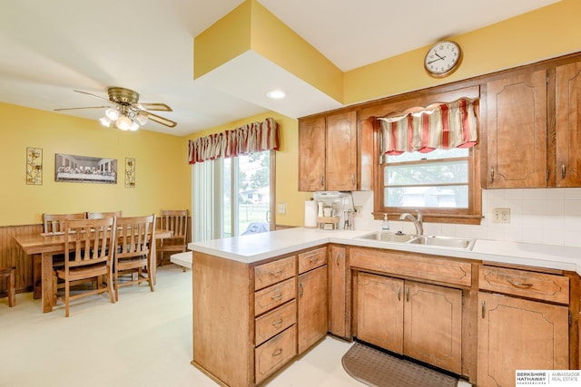 280 N 8th St, Springfield, NE 68059 - kitchen with a peninsula, ceiling fan, light countertops, and backsplash