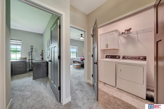 8178 Regent Dr, Lincoln, NE 68507 - washroom featuring cabinet space, independent washer and dryer, light colored carpet, and ceiling fan