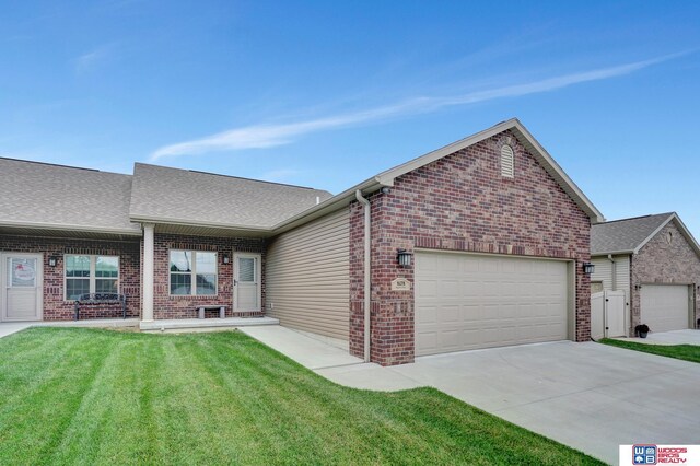 8178 Regent Dr, Lincoln, NE 68507 - ranch-style home with brick siding, a garage, a front yard, driveway, and roof with shingles