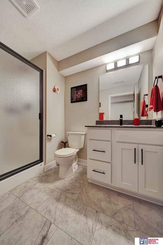 8178 Regent Dr, Lincoln, NE 68507 - bathroom with marble finish flooring, vanity, a stall shower, and a textured ceiling