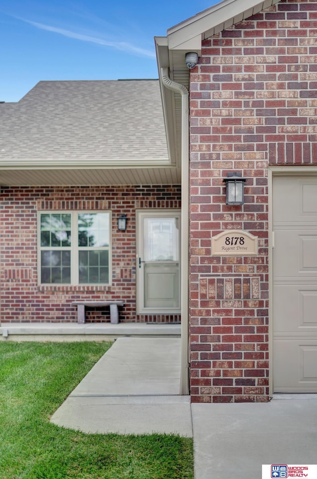 8178 Regent Dr, Lincoln, NE 68507 - property entrance featuring brick siding and a shingled roof