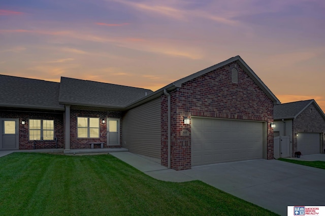 8178 Regent Dr, Lincoln, NE 68507 - view of front of property with brick siding, a garage, driveway, a front lawn, and roof with shingles