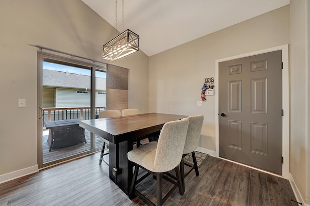 8178 Regent Dr, Lincoln, NE 68507 - dining area featuring a chandelier, dark wood finished floors, and high vaulted ceiling