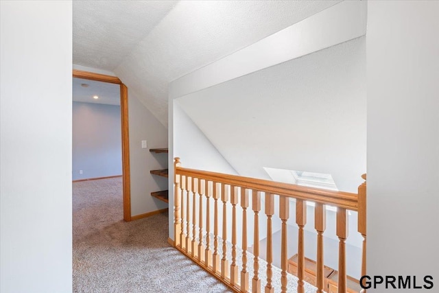 3018 Frederick St S, Omaha, NE 68105 - corridor with lofted ceiling, carpet flooring, an upstairs landing, a skylight, and a textured ceiling