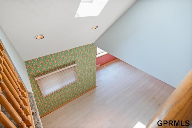3018 Frederick St S, Omaha, NE 68105 - detailed view of wallpapered walls, a skylight, wood finished floors, an accent wall, and recessed lighting