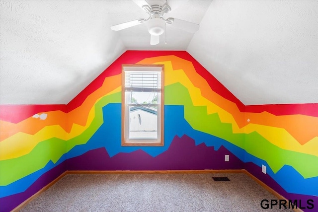 3018 Frederick St S, Omaha, NE 68105 - additional living space with a ceiling fan, carpet flooring, vaulted ceiling, and a textured ceiling