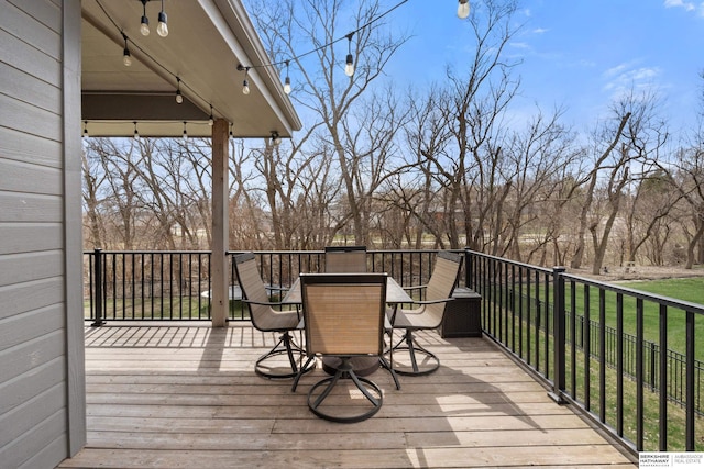 2506 N 188th St, Elkhorn, NE 68022 - deck with outdoor dining area, a lawn, and view of scattered trees