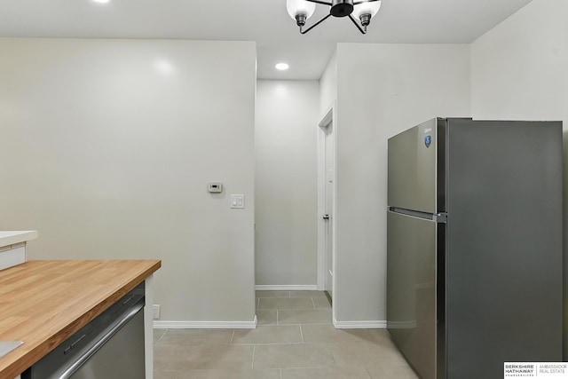 3410 U St, Omaha, NE 68107 - kitchen featuring appliances with stainless steel finishes, butcher block countertops, light tile patterned flooring, a chandelier, and recessed lighting