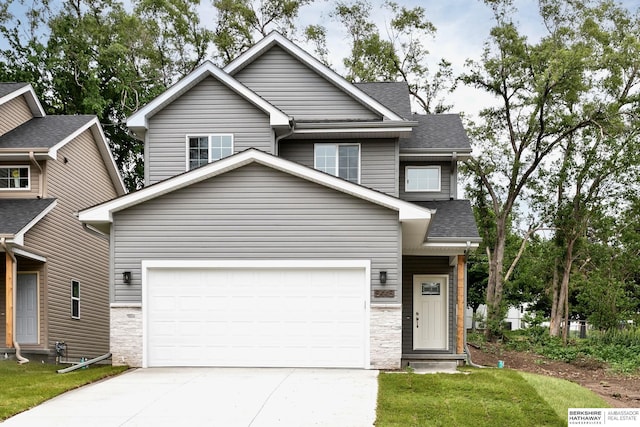 5445 S 51st St, Omaha, NE 68117 - view of front facade with driveway, a shingled roof, stone siding, a front yard, and an attached garage