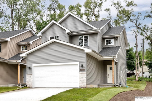 5445 S 51st St, Omaha, NE 68117 - view of front facade featuring concrete driveway, a shingled roof, an attached garage, and a front lawn
