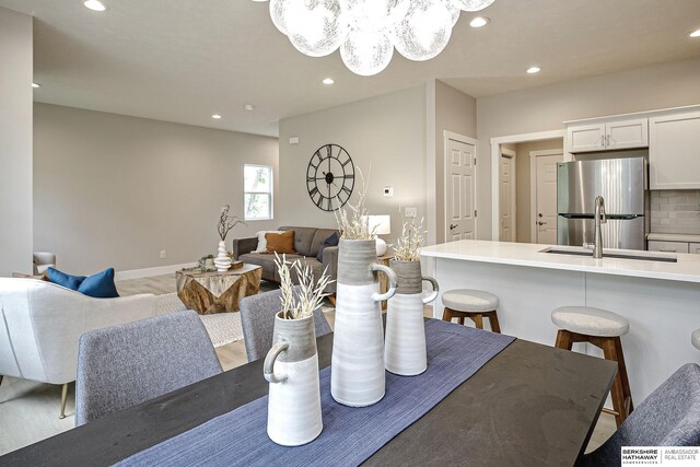 5445 S 51st St, Omaha, NE 68117 - dining area featuring recessed lighting, a chandelier, and light wood-style floors