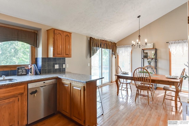 6705 Hillcrest Ln, La Vista, NE 68128 - kitchen featuring dishwasher, lofted ceiling, brown cabinets, tasteful backsplash, and light wood-style flooring