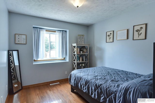 6705 Hillcrest Ln, La Vista, NE 68128 - bedroom featuring wood finished floors and a textured ceiling