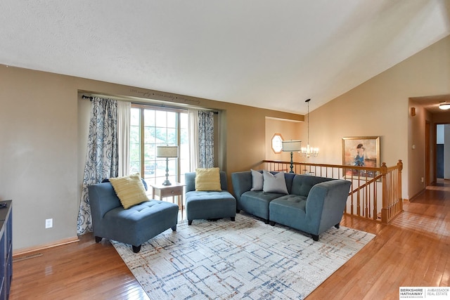 6705 Hillcrest Ln, La Vista, NE 68128 - living room with a chandelier, light wood-type flooring, and vaulted ceiling