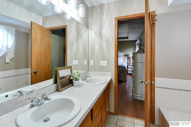 6705 Hillcrest Ln, La Vista, NE 68128 - bathroom featuring ensuite bathroom, tile patterned flooring, double vanity, and a tub to relax in