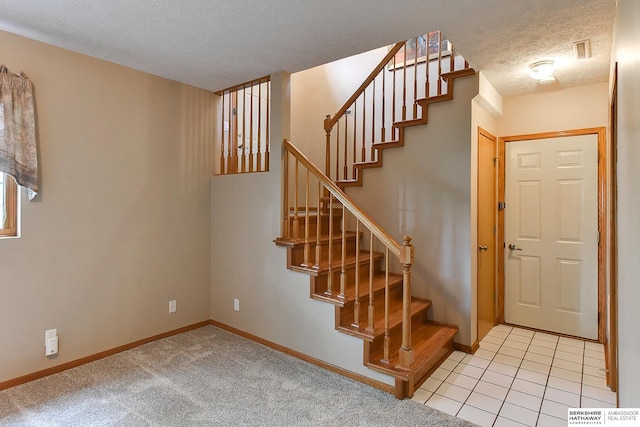 6705 Hillcrest Ln, La Vista, NE 68128 - stairway featuring a textured ceiling and baseboards