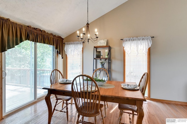 6705 Hillcrest Ln, La Vista, NE 68128 - dining room with vaulted ceiling, a chandelier, and light wood-style floors