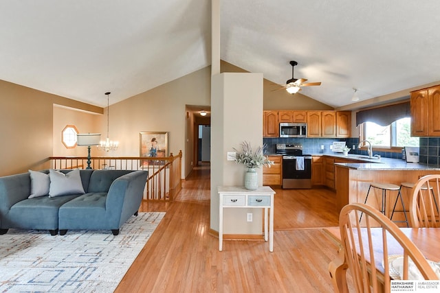 6705 Hillcrest Ln, La Vista, NE 68128 - kitchen featuring stainless steel appliances, lofted ceiling, a chandelier, light wood-style flooring, and ceiling fan