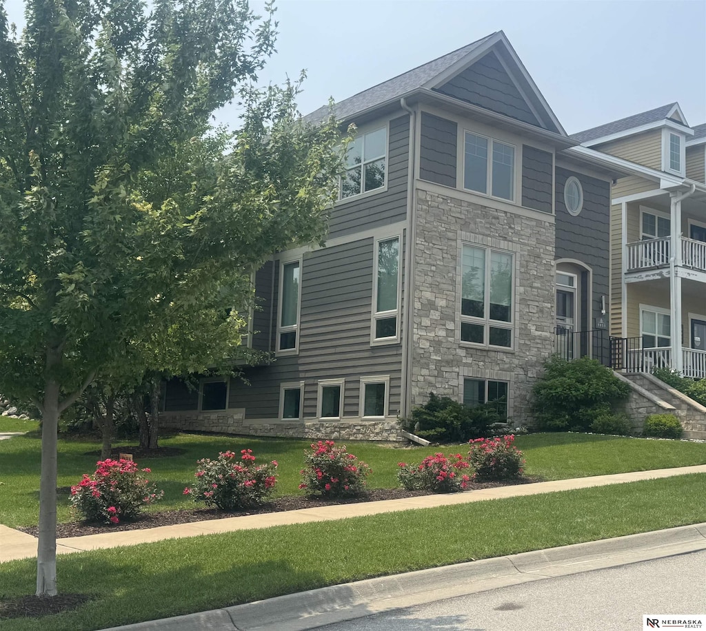 5933 Minter Ln, Lincoln, NE 68516 - view of side of home with stone siding and a yard