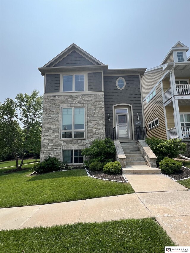 5933 Minter Ln, Lincoln, NE 68516 - view of front of house with stone siding and a front yard