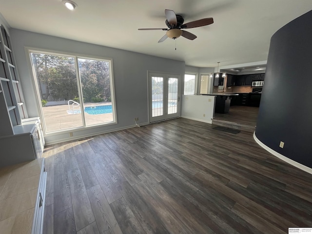 13406 Erskine St, Omaha, NE 68164 - unfurnished living room featuring ceiling fan, plenty of natural light, and dark wood-style floors